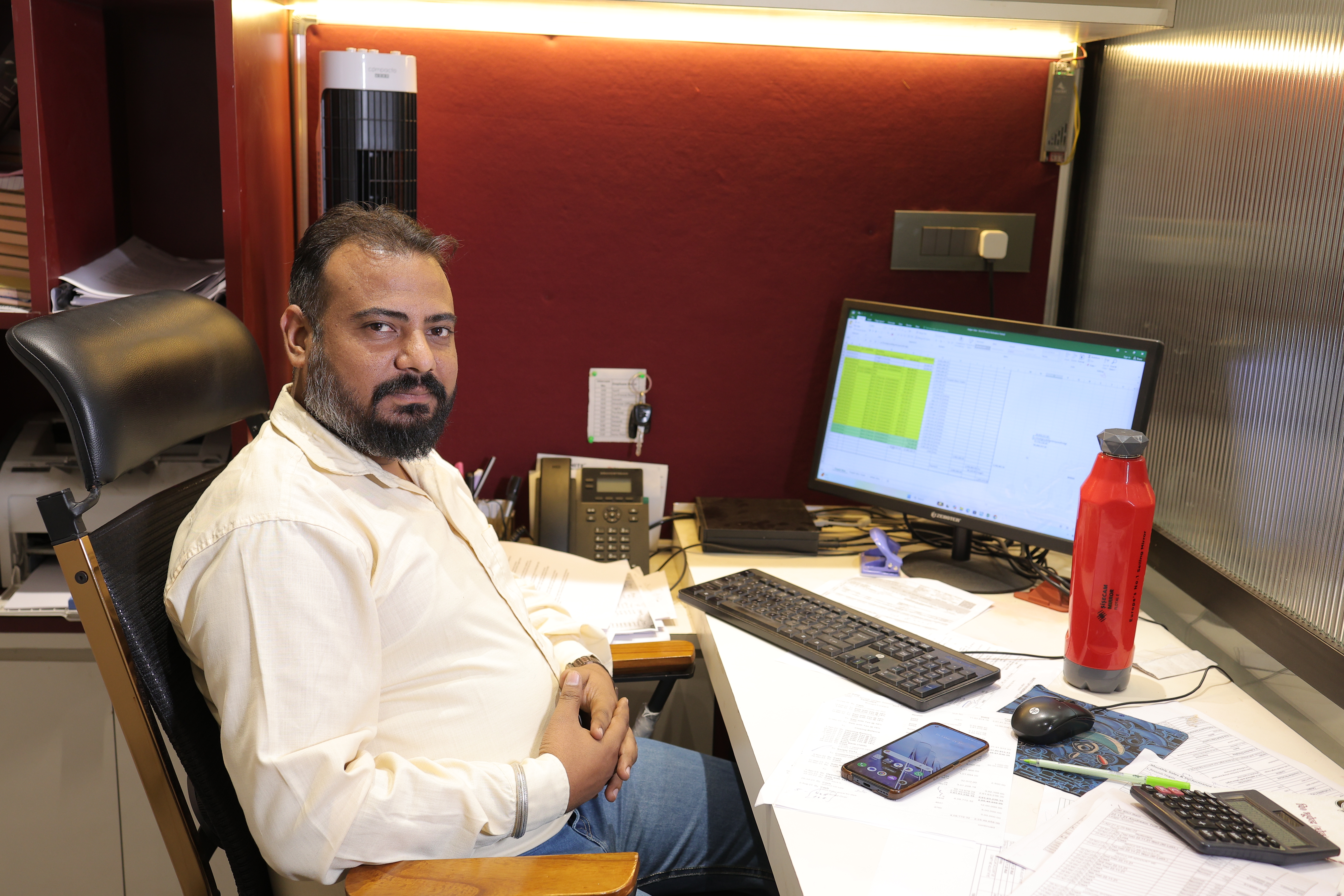 Tirupati Glass office team member at desk